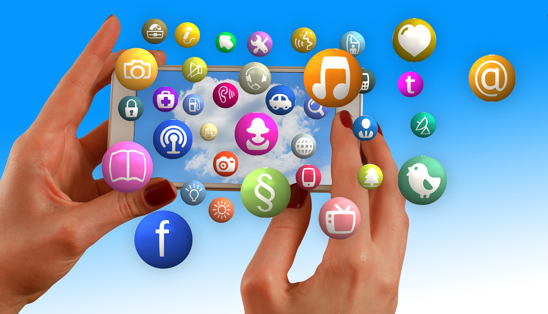 Abstract image of lady's hands holding smartphone with social media icons flying out the screen.