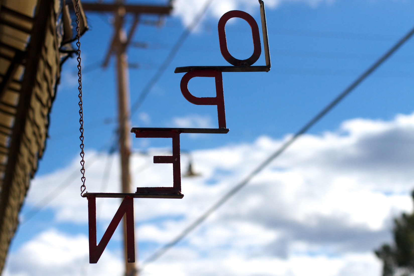 Sign with the word open photographed from the wrong side